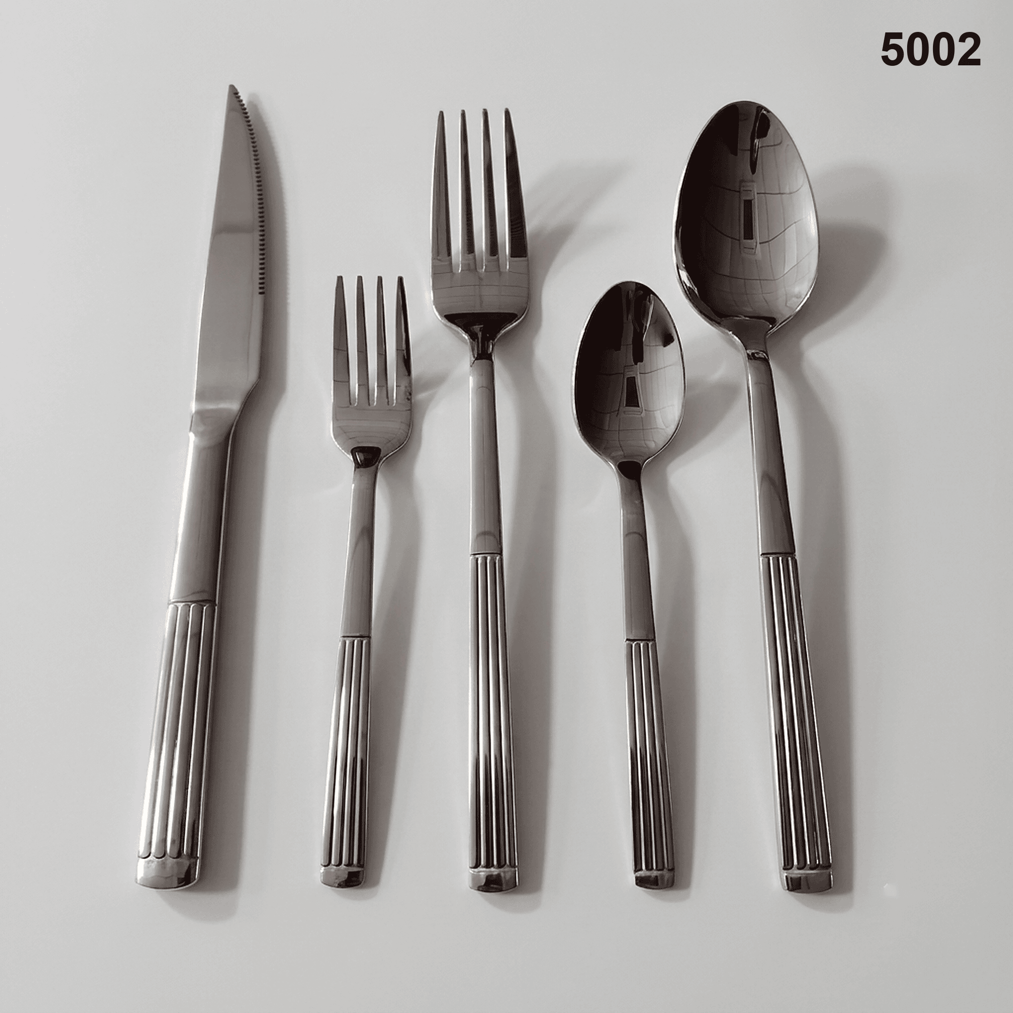 5002 vertical fluted lower handles with a rounded terminal detail and polished utensil heads 20-piece flatware set