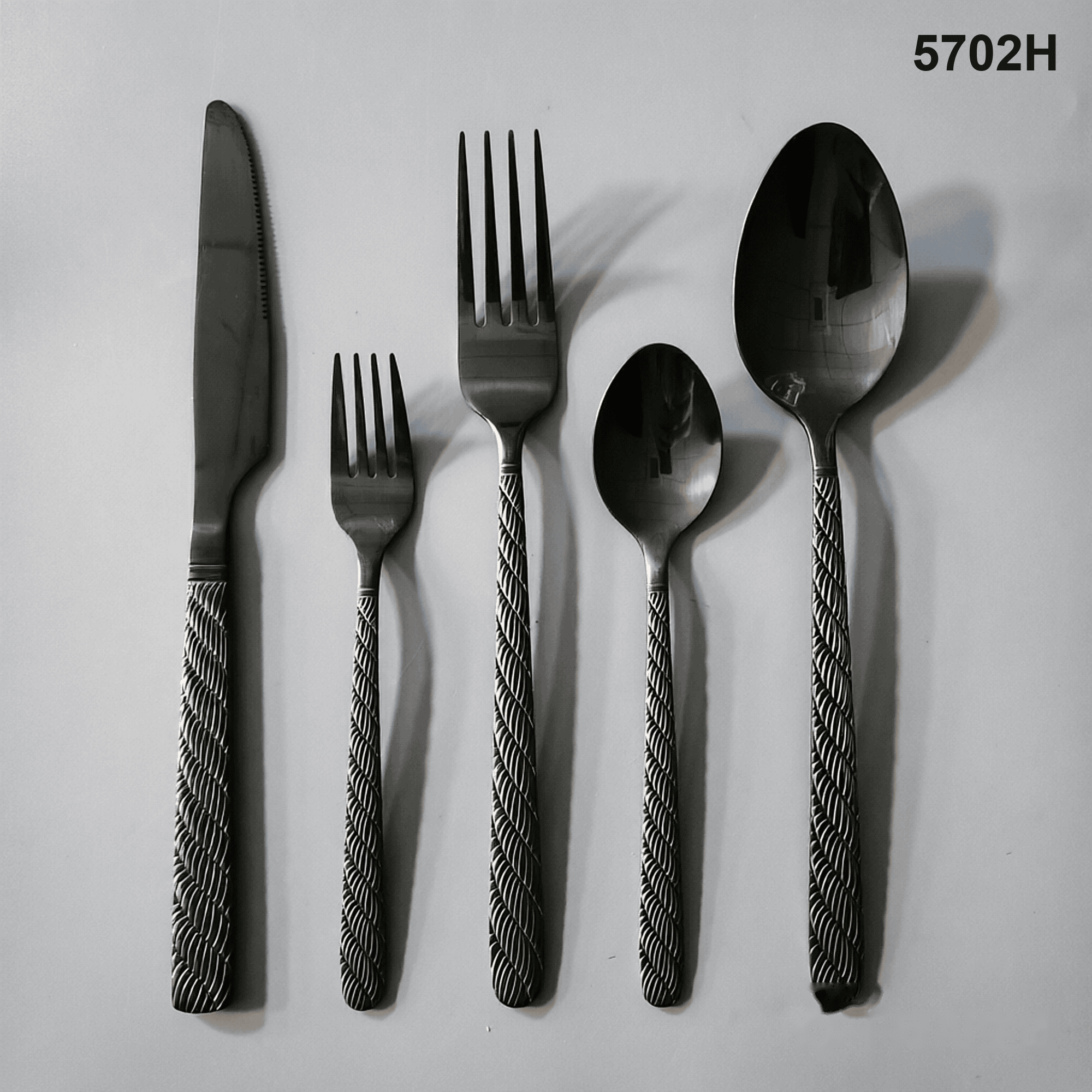 5702H repeating diagonal braided or rope-like texture running down the handles 20-piece flatware set