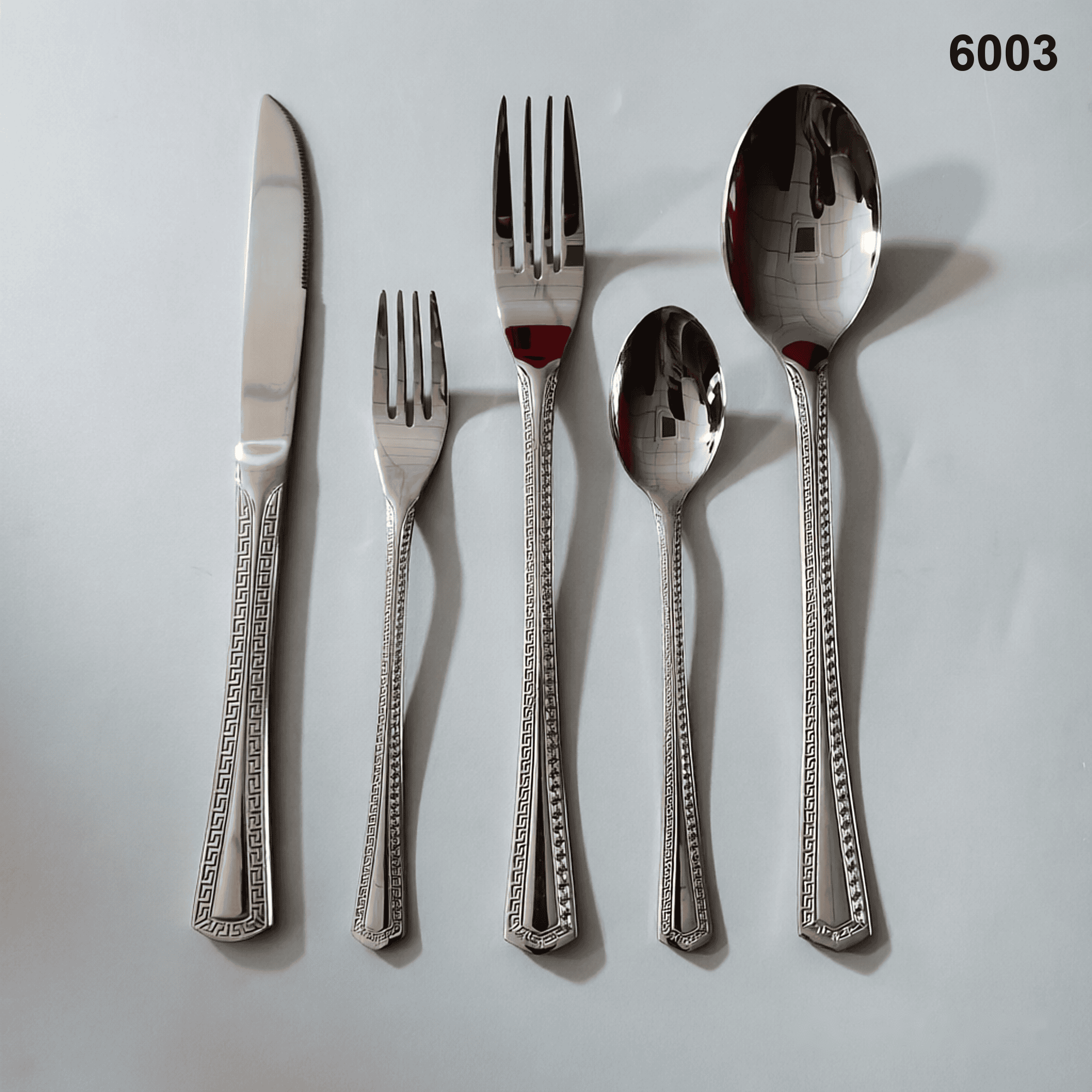 6003 a classic Greek-key meander border framing the smooth central handle channel 20-piece flatware set