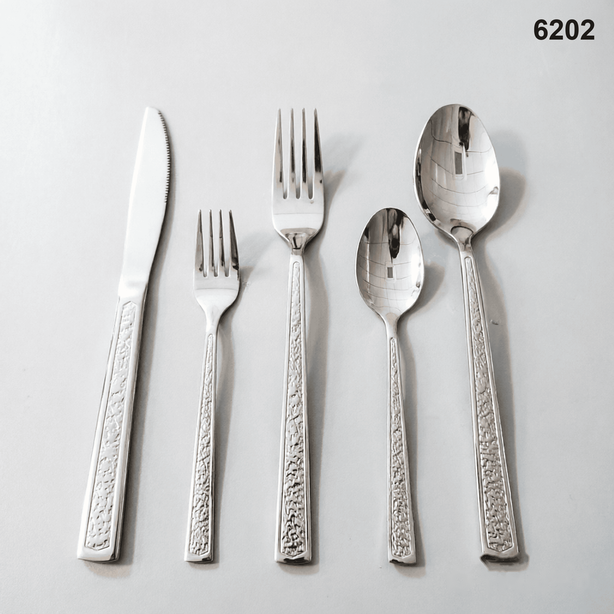6202 a recessed textured center panel framed by a smooth raised geometric border 20-piece flatware set